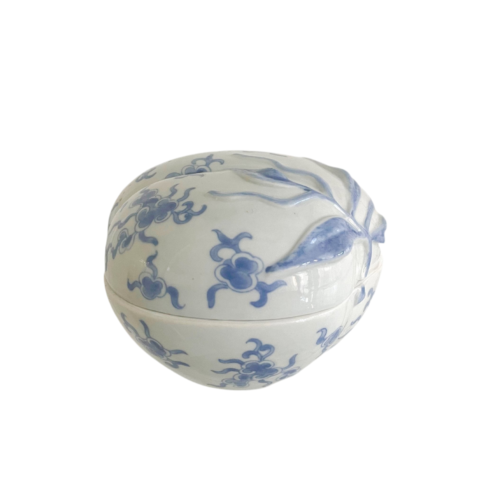 White ceramic container with blue floral patterns on a white background