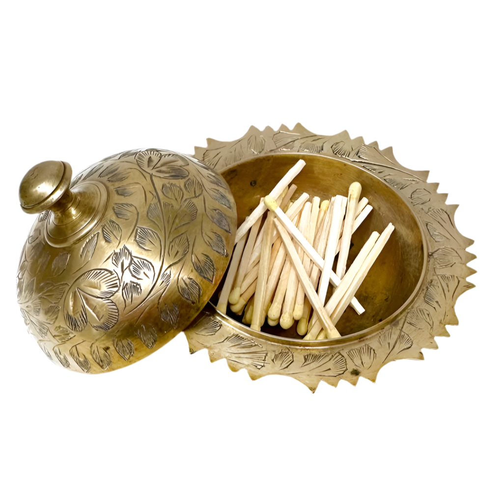 Decorative brass matches holder with matches on a white background