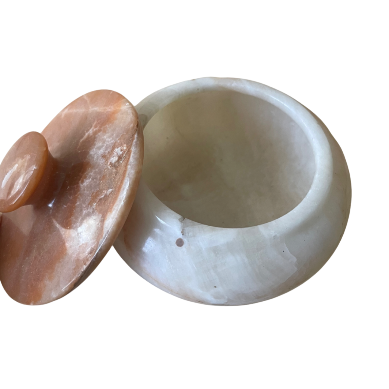 White stone bowl with a pinkish-orange stone on a white background