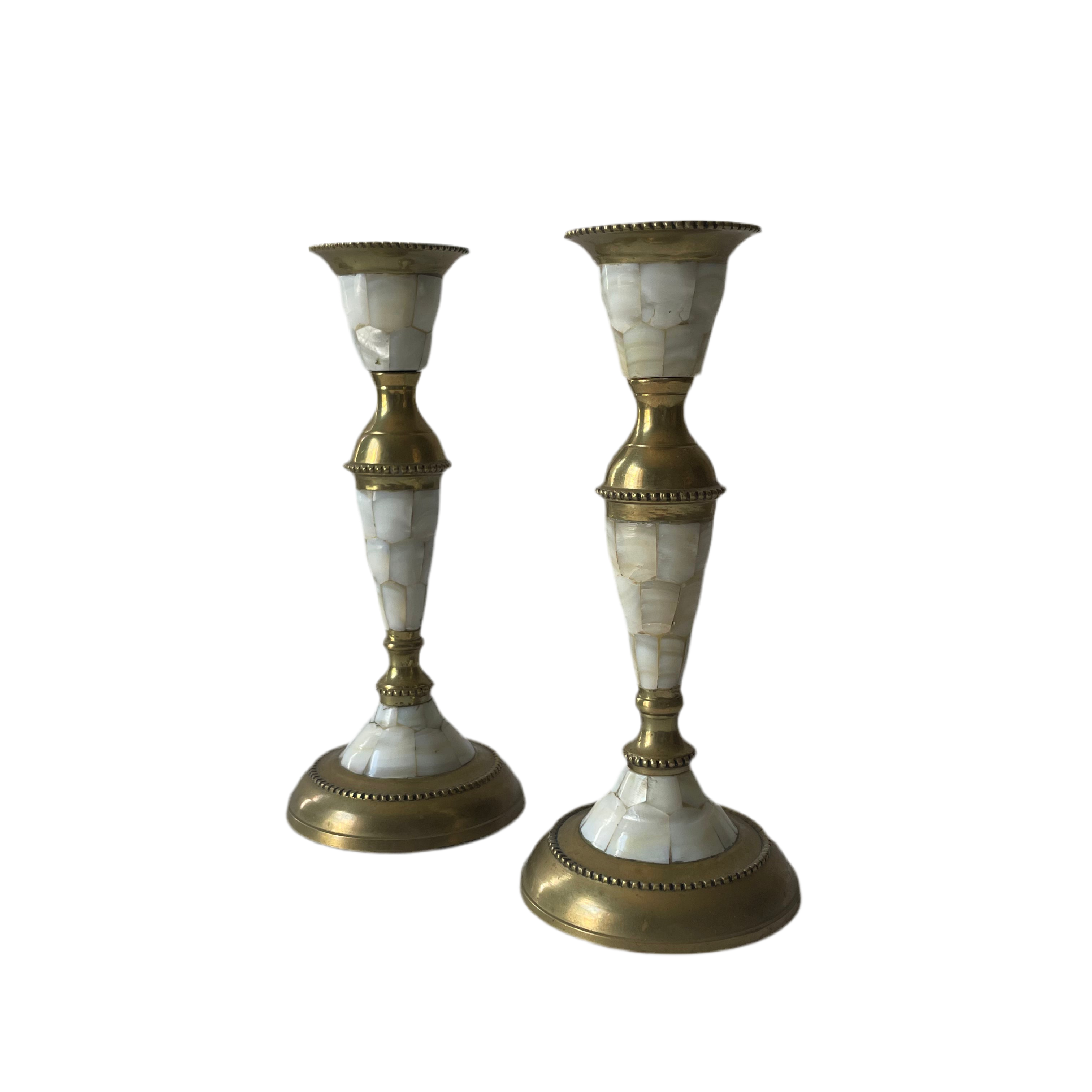 Two decorative candle holders with marble and gold design on a white background