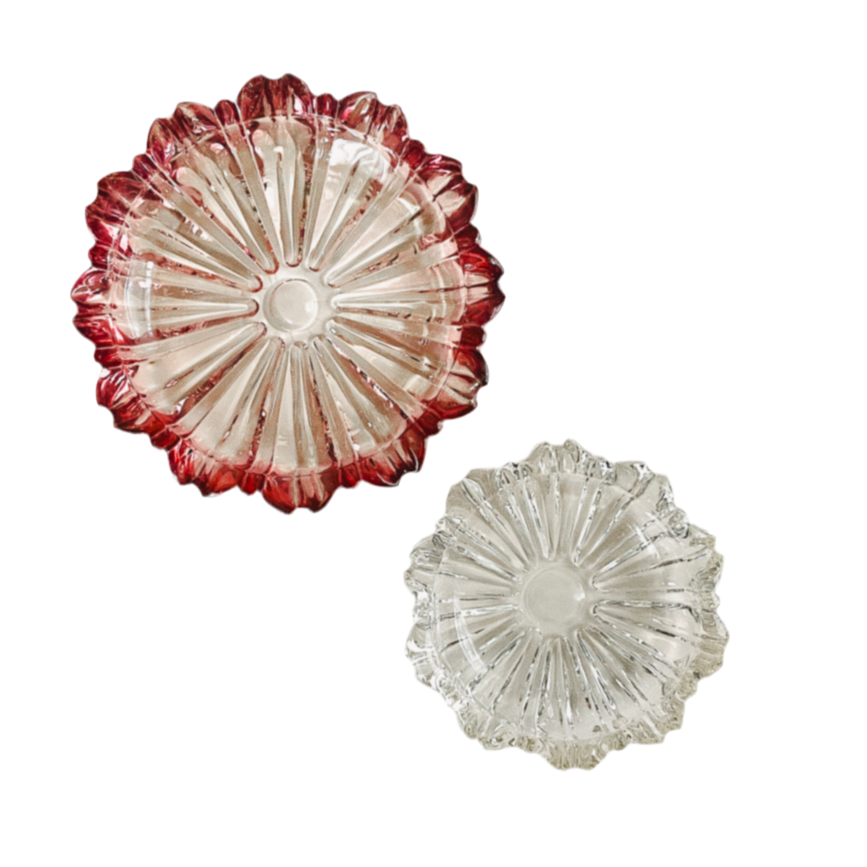 Two decorative glass plates with red and clear designs on a white background